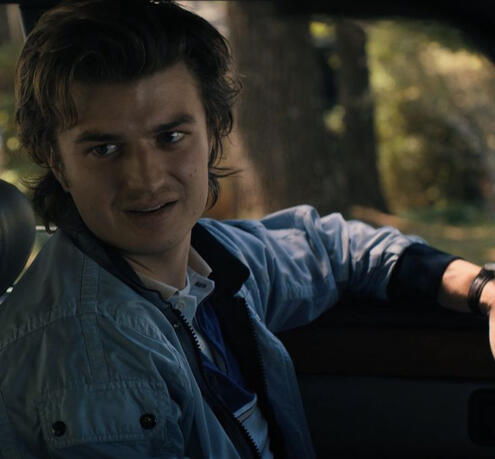 a non-canon v posing in lizzie's bar with a blue netrunner suit on and a pink and white bullet-proof vest